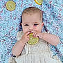 baby, infant, lemon, fruit, blanket, pattern, clothing, cute, hand, face, skin, eyes, mouth, lying_down, natural_light, texture, outdoor, fresh, playful, child