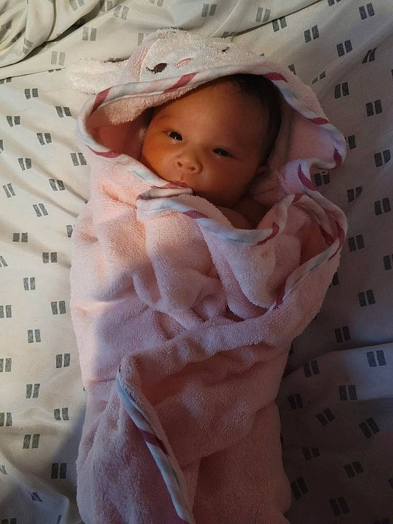 Elianna is registered to the contest to win money with this photo: baby, baby_products, baby_safety, baby_sleeping, baby_toddler_clothing, bedding, cheek, child, comfort, fashion_accessory, fur, linens, lip, pattern, peach, person, pink, product, skin, sleeve