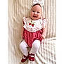 Billy-Ellen is registered to the contest to win money with this photo: baby, infant, smiling, headband, white_bow, red_shoes, white_tights, strawberry_embroidery, red_and_white_outfit, blanket, soft_texture, cute, happy, portrait, child, lying_down, clothing, indoors, cheerful, young_child