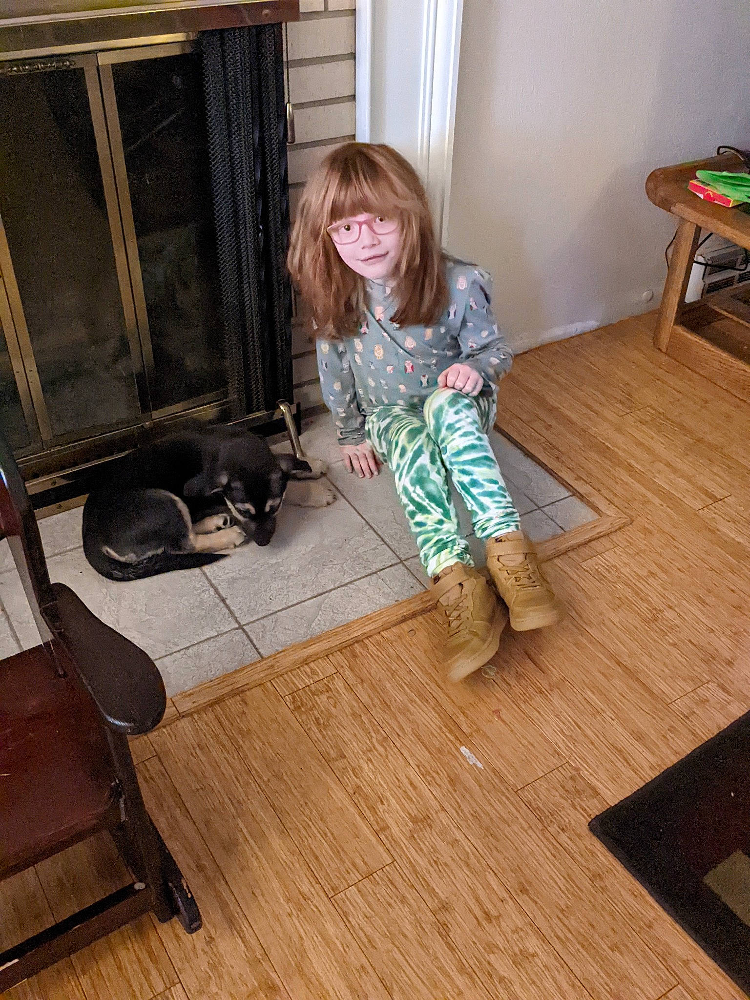 Taylor is registered to the contest to win money with this photo: chair, comfort, door, floor, flooring, foot, hardwood, human_leg, laminate_flooring, living_room, pattern, person, plank, plywood, room, sitting, toddler, varnish, wood, wood_flooring