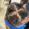 Michael is registered to the contest to win money with this photo: adult_arm, black_clothing, blue, braids, chair, child, close_up, cornrows, curly_hair, fire_extinguisher, hair_accessories, haircare, hairstyle, indoor, overhead_view, photography, portrait, salon, tile_floor, toddler