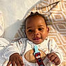Michael joined the competition — help win amazing prizes! baby, bed, bedding, blanket, child, closeup, cozy, face, geometric_pattern, hands, happy, indoor, infant, lying_down, onesie, pacifier, pacifier_clip, portrait, smiling, toy