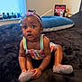 Endia is registered to the contest to win money with this photo: baby, child, infant, sitting, colorful_clothing, sparkly_shoes, headband, curly_hair, indoors, window, cushion, plush_surface, wide_eyes, cute, person, young_child, black_baby, expression, room, soft_lighting