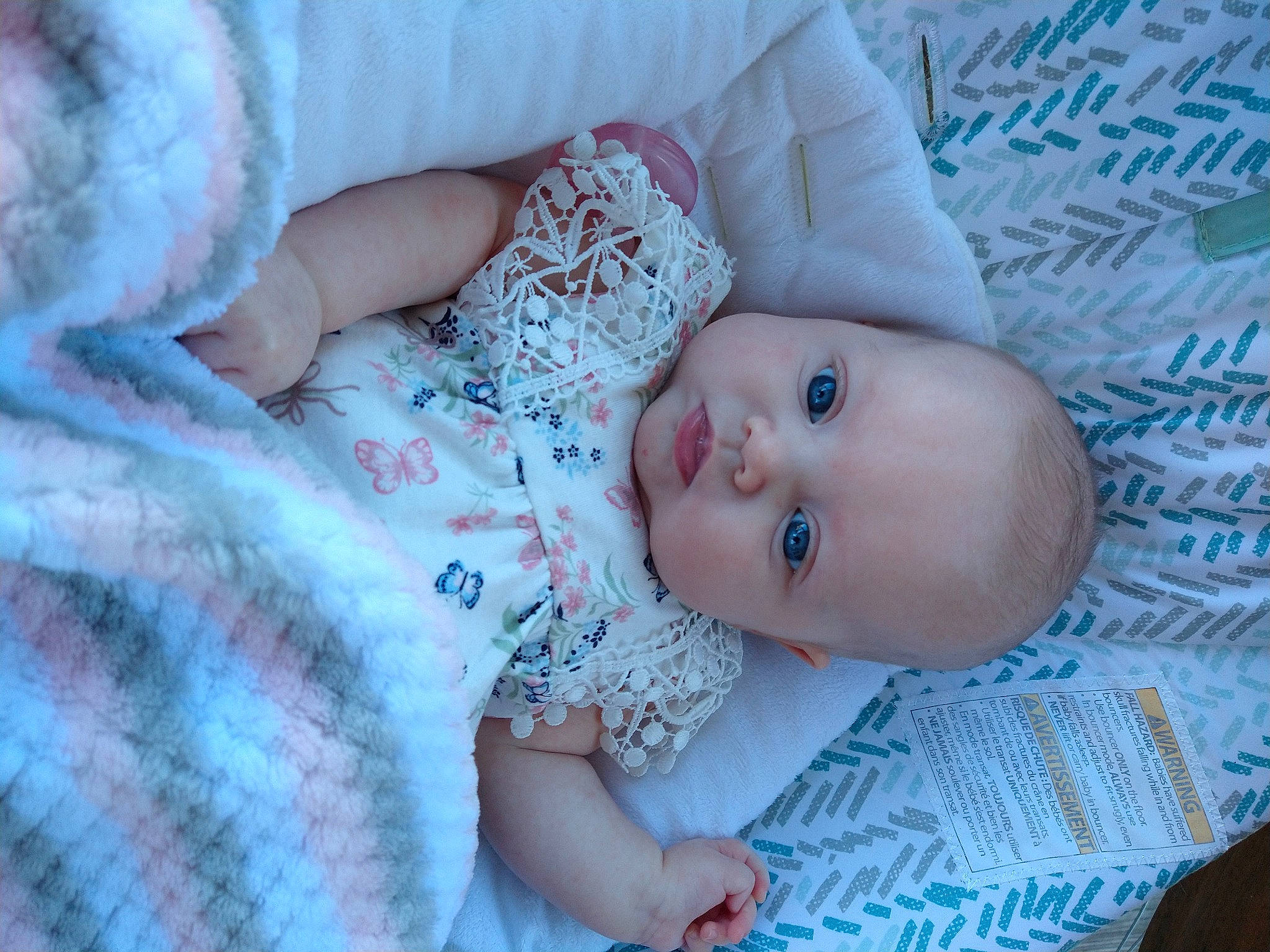Ella is registered to the contest to win money with this photo: azure, baby, baby_toddler_clothing, cheek, comfort, eye, finger, hand, head, human_body, iris, linens, mammal, pattern, person, pink, product, skin, textile, toddler