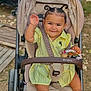 Méeva participe au concours pour gagner de l'argent avec cette photo : toddler, child, stroller, yellow_dress, curled_hair, pigtails, smiling, waving_hand, outdoor, toy, beads, barefoot, seatbelt, baby, cute, person, happy, park, nature, portrait