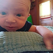 Vincent is registered to the contest to win money with this photo: baby, bed, bedroom, blanket, bodypart, couch, cushion, face, finger, furniture, hand, head, homedecor, indoors, newborn, person, photography, portrait, quilt, room