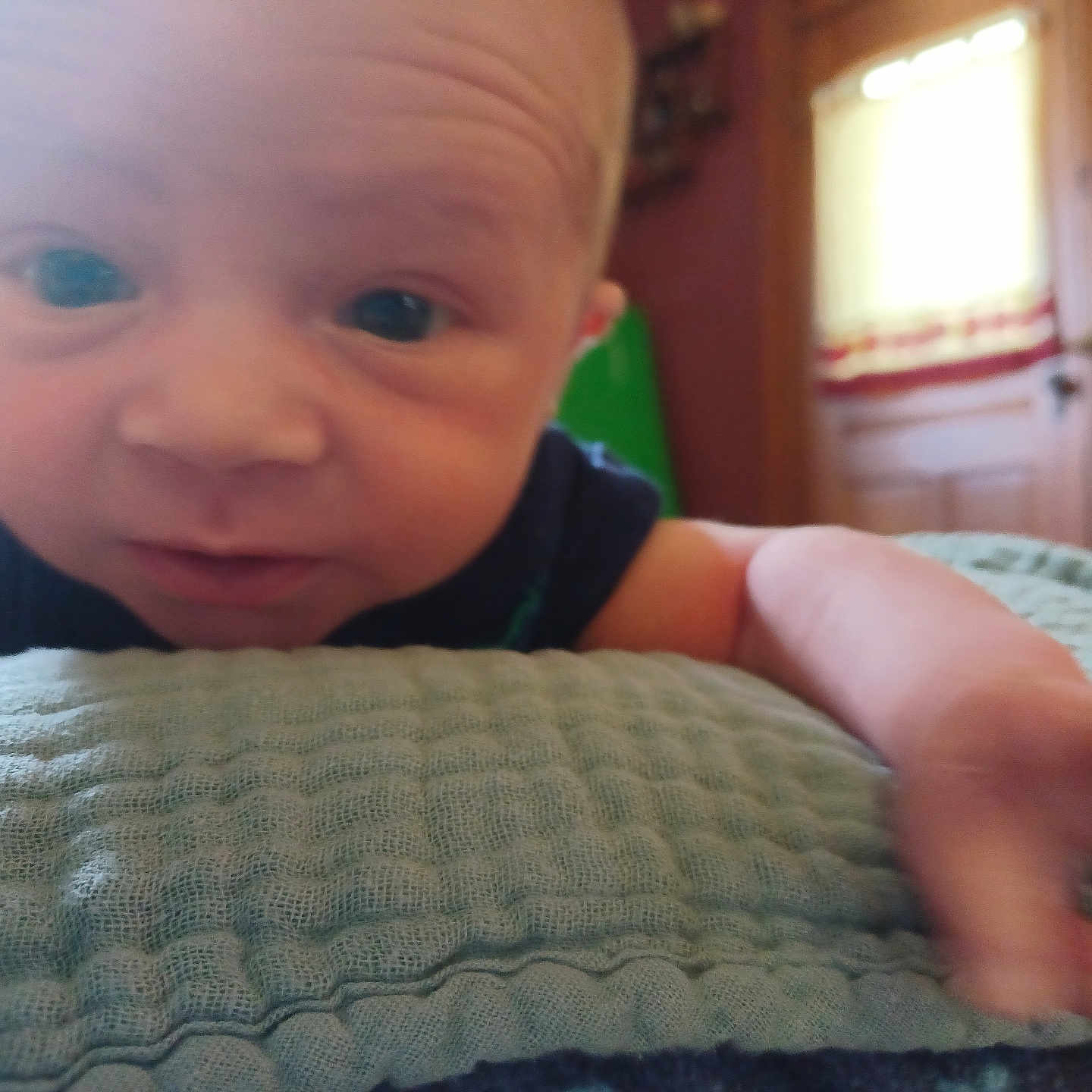 Vincent is registered to the contest to win money with this photo: baby, bed, bedroom, blanket, bodypart, couch, cushion, face, finger, furniture, hand, head, homedecor, indoors, newborn, person, photography, portrait, quilt, room