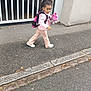 Melyne Marie a rejoint le concours — aidez-le/la à gagner de superbes lots ! child, girl, walking, pink_jacket, backpack, plush_toy, sidewalk, urban, street, asphalt, concrete_wall, gate, curb, casual_clothing, outdoor, daylight, person, footwear, hair, playful
