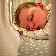 Finley joined the competition — help win amazing prizes! baby, sleeping, crib, pajamas, giraffe_print, blanket, mesh, infant, face, peaceful, child, closeup, soft_lighting, indoors, cute, resting, young, bed, comfort, toddler