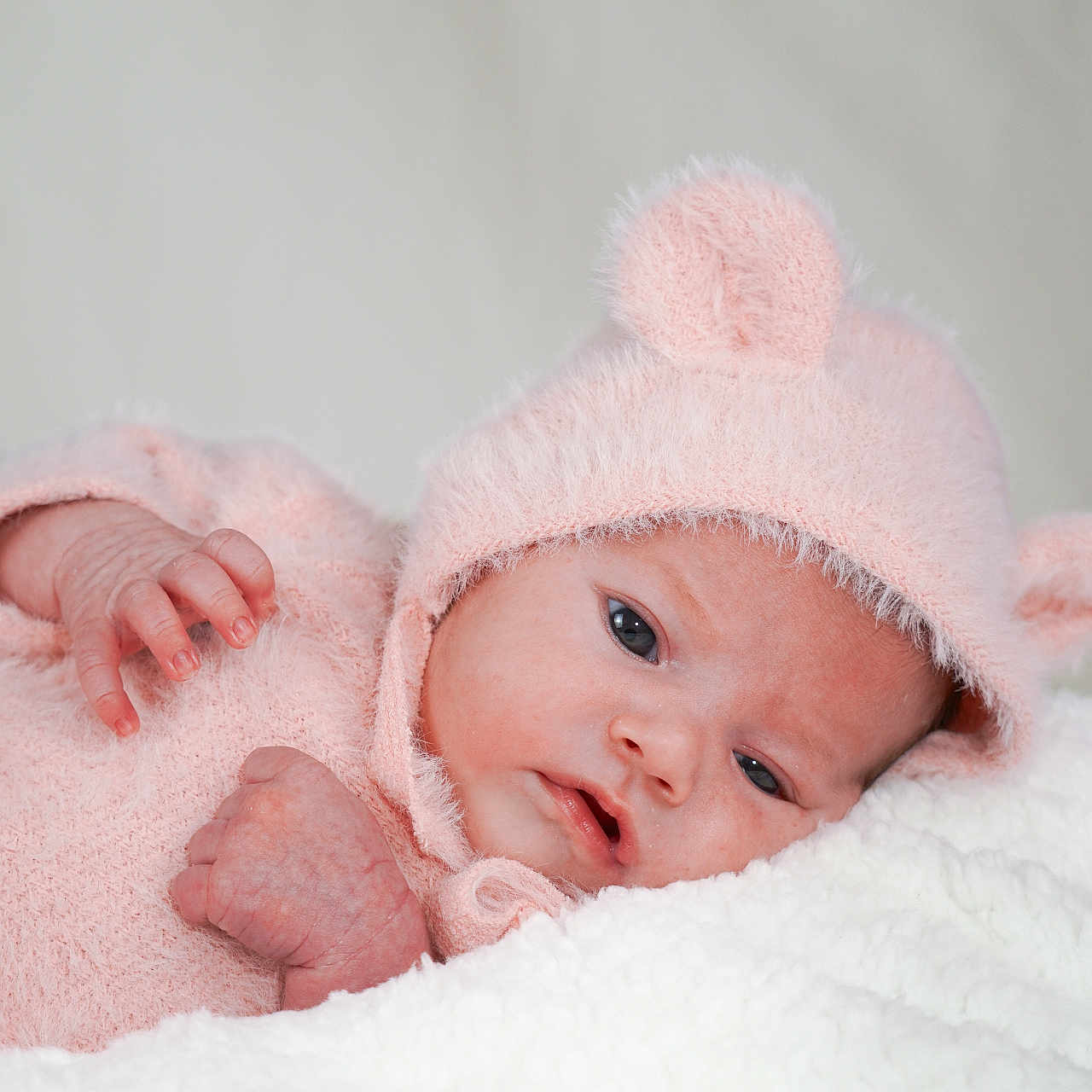 Denissa participe au concours pour gagner de l'argent avec cette photo : baby, bear_ears, blanket, child, close_up, cozy, cute, face, hand, hat, indoors, infant, lying_down, newborn, pink_clothing, portrait, sleepy, soft_texture, toddler, warm