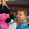 baby, child, infant, smiling, happy, sitting, walker, toy, stuffed_animal, pink, blue, playpen, indoor, home, portrait, face, eyes, blond_hair, baby_clothing, playroom