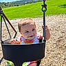 Margaret is registered to the contest to win money with this photo: baby, swing, playground, child, outdoor, sunny, grass, woodchips, smile, happy, summer, daylight, park, nature, person, seat, metal_chain, clothing, face, fun