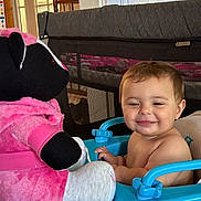 Margaret joined the competition — help win amazing prizes! baby, child, toddler, smiling, happy, face, portrait, indoor, home, playroom, walker, baby_walker, stuffed_animal, plush_toy, pink, blue, playpen, sitting, infant, toy
