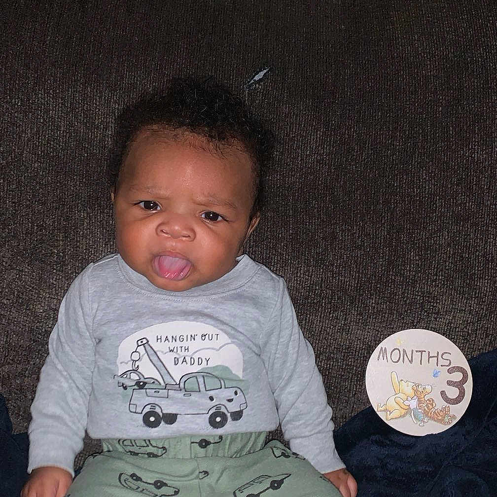 Ajavion is registered to the contest to win money with this photo: baby, bodypart, clothing, couch, cushion, face, furniture, happy, head, homedecor, indoors, laughing, mouth, pants, person, photography, portrait, shorts, sitting, t_shirt