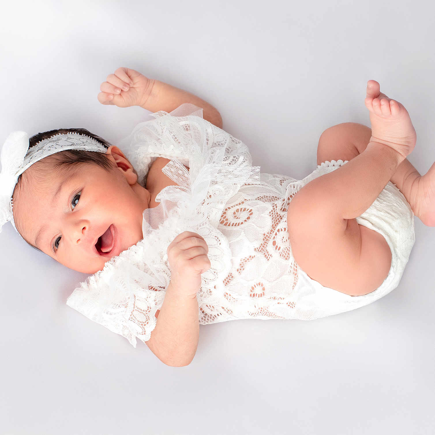 Rubab is registered to the contest to win money with this photo: baby, infant, white_lace, headband, newborn, cute, lying_down, happy, soft_background, skin, small_feet, tiny_hands, portrait, child, smiling, innocent, studio_photo, white_clothing, fresh, peaceful