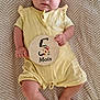 Mia a rejoint le concours — aidez-le/la à gagner de superbes lots ! baby, blanket, child, cute, eyes, face, five_months, floral_design, foot, hand, indoors, infant, lying_down, newborn, portrait, romper, skin, soft_texture, wooden_sign, yellow_clothing