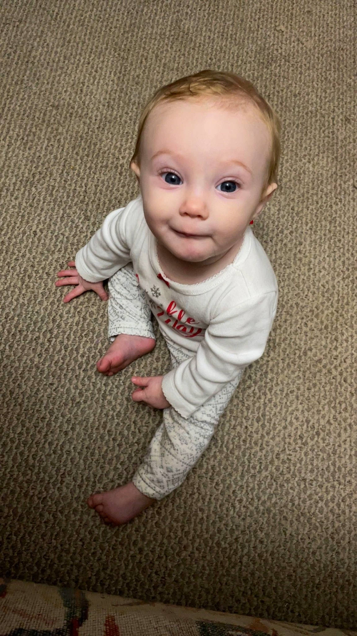 Everly is registered to the contest to win money with this photo: baby, baby_toddler_clothing, cheek, child, comfort, eye, face, floor, flooring, fun, grey, hardwood, head, human_body, pattern, person, sitting, sleeve, t_shirt, toddler