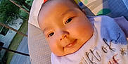 Nahanni is registered to the contest to win money with this photo: baby, cheeks, child, closeup, clothing, cushion, daylight, face, happy, head, infant, nature, outdoor, person, portrait, relaxing, smile, soft, tree, young