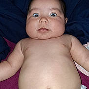 Nahanni is registered to the contest to win money with this photo: baby, diaper, surprised, chubby_cheeks, lying_down, bare_chest, infant, face, skin, expression, blanket, blue, pink, human, cute, child, newborn, indoors, portrait, young