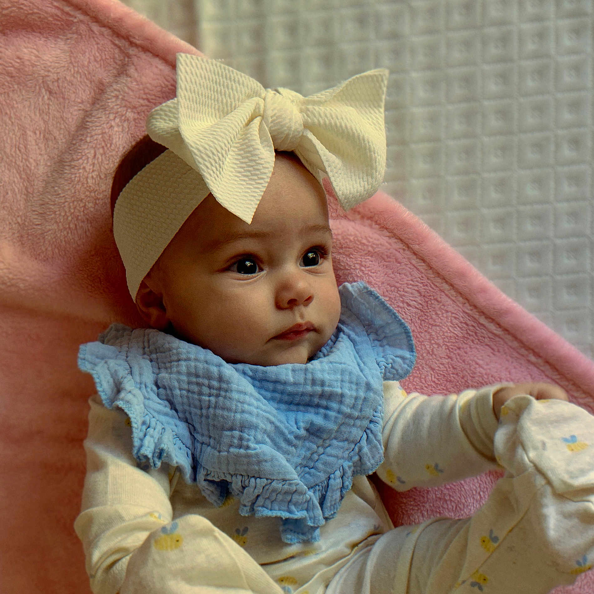 Alynneise is registered to the contest to win money with this photo: adorable, baby, blue_bib, bow, child, closeup, cozy, cute, expression, face, headband, indoors, infant, lying_down, newborn, pajamas, pink_blanket, portrait, sleepwear, soft_texture