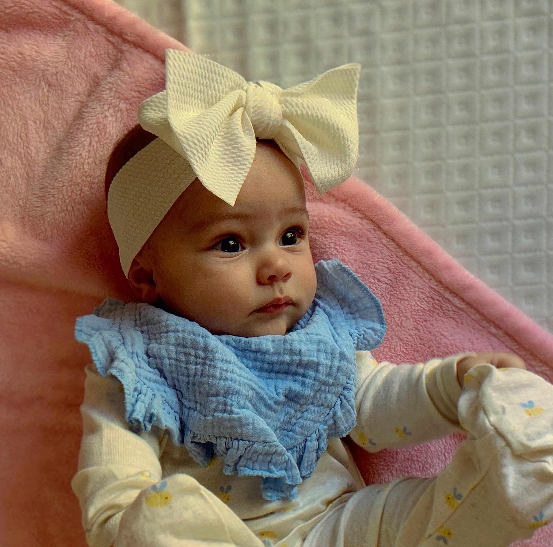 Alynneise is registered to the contest to win money with this photo: baby, child, headband, bow, blue_bib, pink_blanket, pajamas, infant, face, cute, lying_down, soft_texture, closeup, indoors, newborn, expression, cozy, sleepwear, adorable, portrait