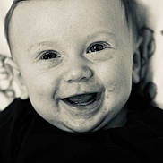 Weston is registered to the contest to win money with this photo: baby, smile, face, closeup, infant, child, black_and_white, happy, eyes, mouth, cute, person, portrait, young, expression, skin, head, clothing, babyclothes, cheerful