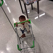 Jaya joined the competition — help win amazing prizes! beverages, bottles, child, floor, food, green_cart, gripping, grocery_store, indoor, juice, portrait, retail, seated, shelves, shopping, shopping_cart, small_child, store, supermarket, toddler