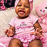baby, baby_photography, blanket, bow, child, dress, face, fluffy, hands, happy, headband, indoor, nursery, pink, portrait, princess, sitting, smiling, stuffed_animal, teddy_bear