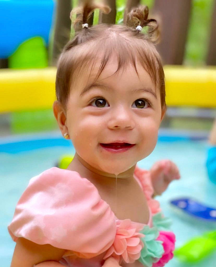 Livia is registered to the contest to win money with this photo: baby, baby_playing_with_toys, baby_toddler_clothing, bathing, child, facial_expression, fun, hairstyle, happy, joy, leisure, organ, person, play, recreation, skin, smile, snapshot, swimming_pool, toddler