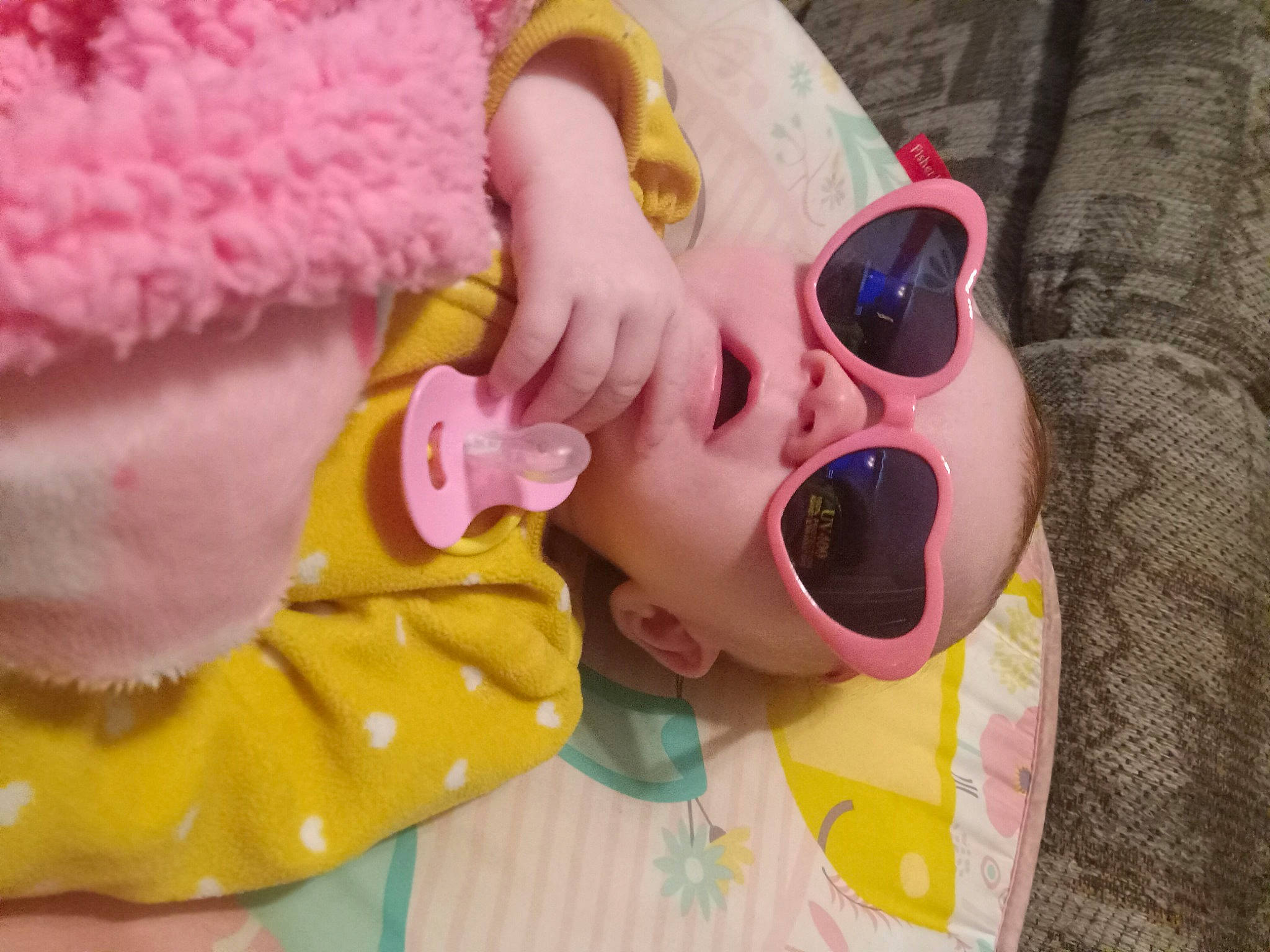 Maribel is registered to the contest to win money with this photo: baby, baby_toddler_clothing, child, ear, eyewear, fun, glasses, goggles, happy, headwear, human_body, lip, magenta, nose, person, pink, plant, smile, sunglasses, textile