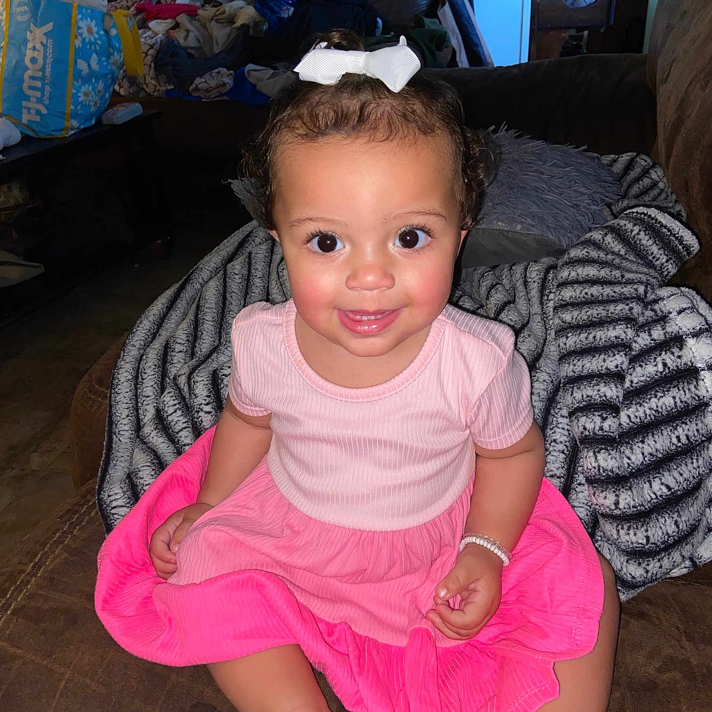 Malahni joined the competition — help win amazing prizes! baby, blanket, bracelet, child, clothing, couch, cute, face, furniture, hair, happy, home, indoor, person, pink_dress, portrait, sitting, smiling, toddler, white_bow