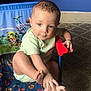 toddler, child, baby, chair, paw_patrol, foot, hand, indoor, carpet, blue_wall, socks, playing, curious, cute, clothing, person, furniture, toy_chair, casual, young_child