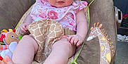 Katie is registered to the contest to win money with this photo: baby, baby_rocker, bib, child, cute, face, feet, garden, giraffe_pattern, grass, hat, infant, legs, outdoor, person, pink_clothing, seat, smile, sunhat, toy