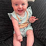 Katie is registered to the contest to win money with this photo: baby, child, smiling, sitting, couch, clothing, happy, cute, infant, face, hand, foot, indoors, portrait, young_child, light_blue, flamingo_print, textured_fabric, cheerful, waving