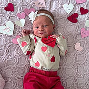 Birdie is registered to the contest to win money with this photo: baby, infant, newborn, heart, valentine, blanket, headband, pink, red, onesie, pants, smile, hand, portrait, cozy, paper_hearts, soft_texture, cute, fabric, decor