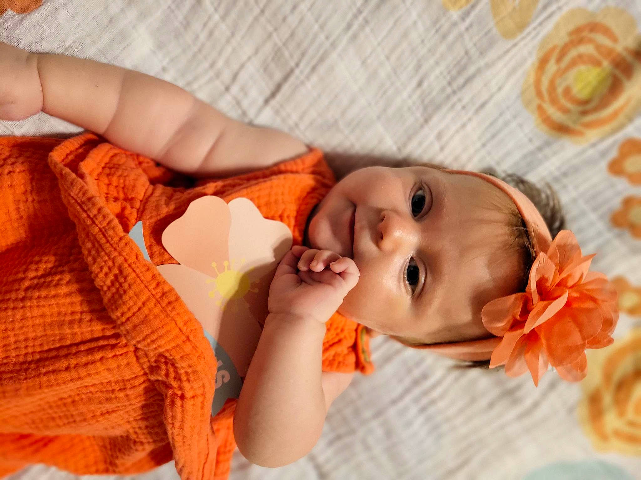 Dorothy joined the competition — help win amazing prizes! baby, baby_toddler_clothing, comfort, eyelash, fashion_accessory, finger, flower, hand, happy, headgear, headpiece, iris, linens, lip, nail, orange, peach, person, petal, skin