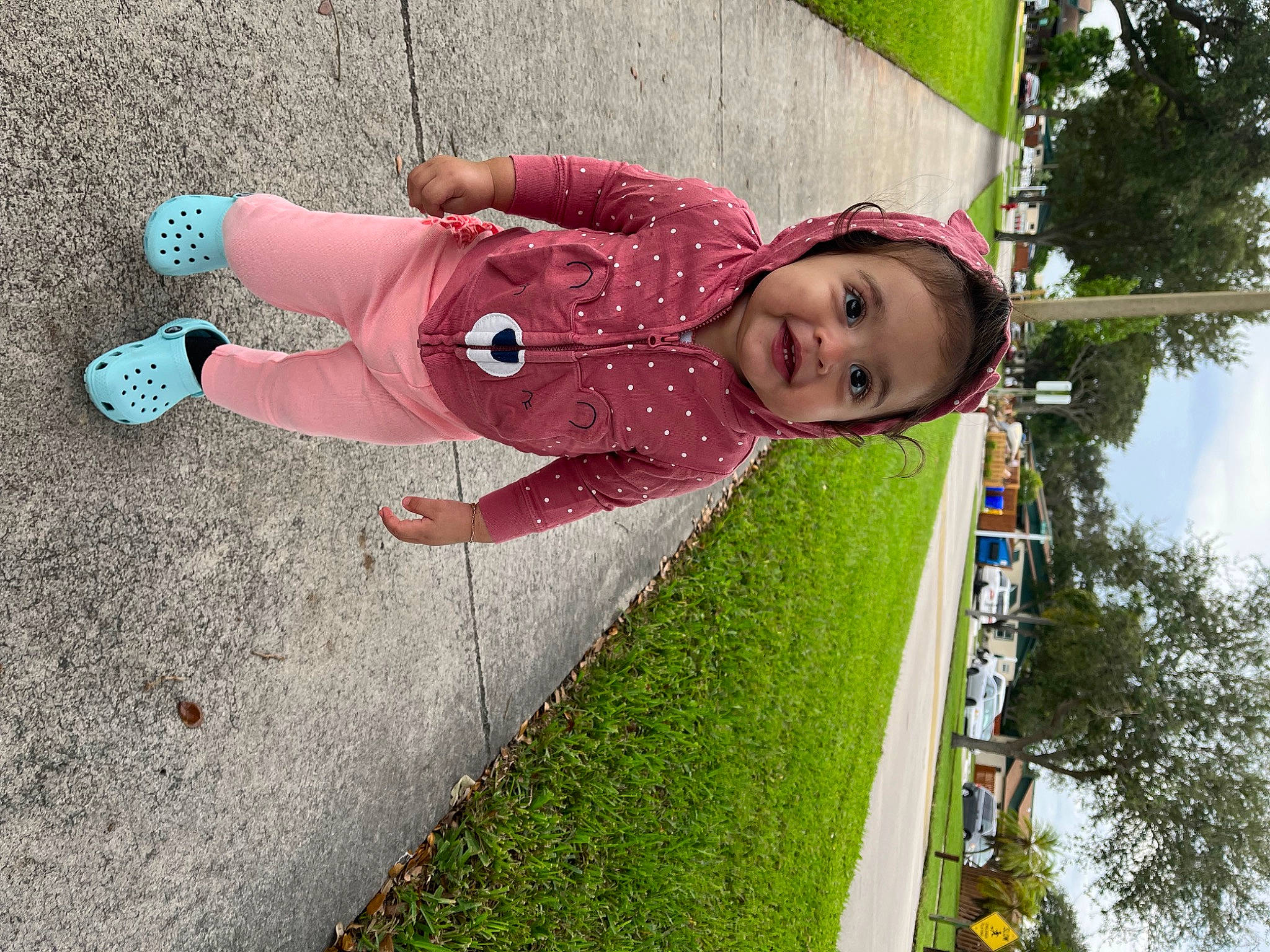 Sophia is registered to the contest to win money with this photo: carmine, child, cloud, fun, grass, happy, house, human_leg, leisure, magenta, people_in_nature, person, plant, pole, recreation, sidewalk, sky, smile, toddler, tree