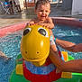 Ilyan participe au concours pour gagner de l'argent avec cette photo : adult_arm, child, dinosaur, family, float, fun, happy, outdoor, people, play, pool, summer, sunlight, swimming_pool, toddler, toy, vacation, water, water_toy, yellow