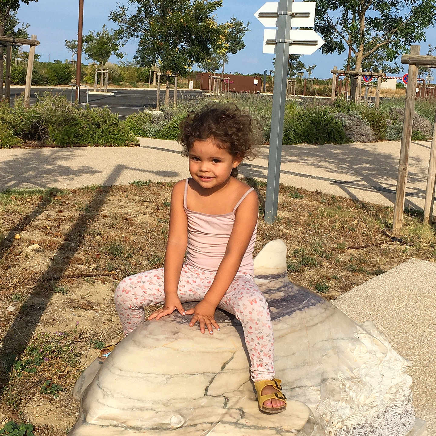 Maily a rejoint le concours — aidez-le/la à gagner de superbes lots ! child, clothing, dress, face, female, flagstone, footwear, girl, head, pants, path, person, photography, plant, portrait, sandal, sitting, slate, tree, walkway
