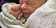 Cayson is registered to the contest to win money with this photo: baby, blanket, child, closeup, clothing, cozy, cute, fabric, face, hand, infant, newborn, peaceful, person, portrait, skin, sleeping, smiling, soft, wrapped