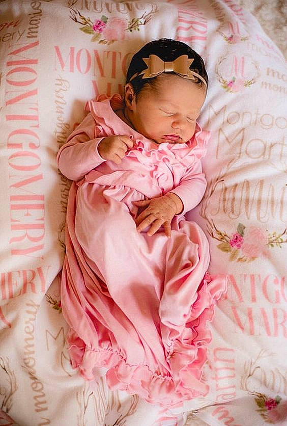 Shanna participe au concours pour gagner de l'argent avec cette photo : baby, baby_products, baby_toddler_clothing, child, day_dress, dress, event, face, happy, linens, magenta, outerwear, pattern, peach, person, petal, pink, ruffle, skin, sleeve