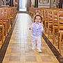 Elyo participe au concours pour gagner de l'argent avec cette photo : aisle, background, bowtie, child, church, curly_hair, event, floor_tiles, formal_clothing, happy, indoor, light, people, person, running, smile, toddler, vest, wooden_chairs, young_child