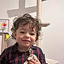 Elyo a rejoint le concours — aidez-le/la à gagner de superbes lots ! casual_clothing, cat_tree, child, curly_hair, cute, furniture, handprint_art, happy, home, indoor, necklace, person, plaid_shirt, portrait, smile, soft_toy, toddler, toy, wooden_cabinet, young_child