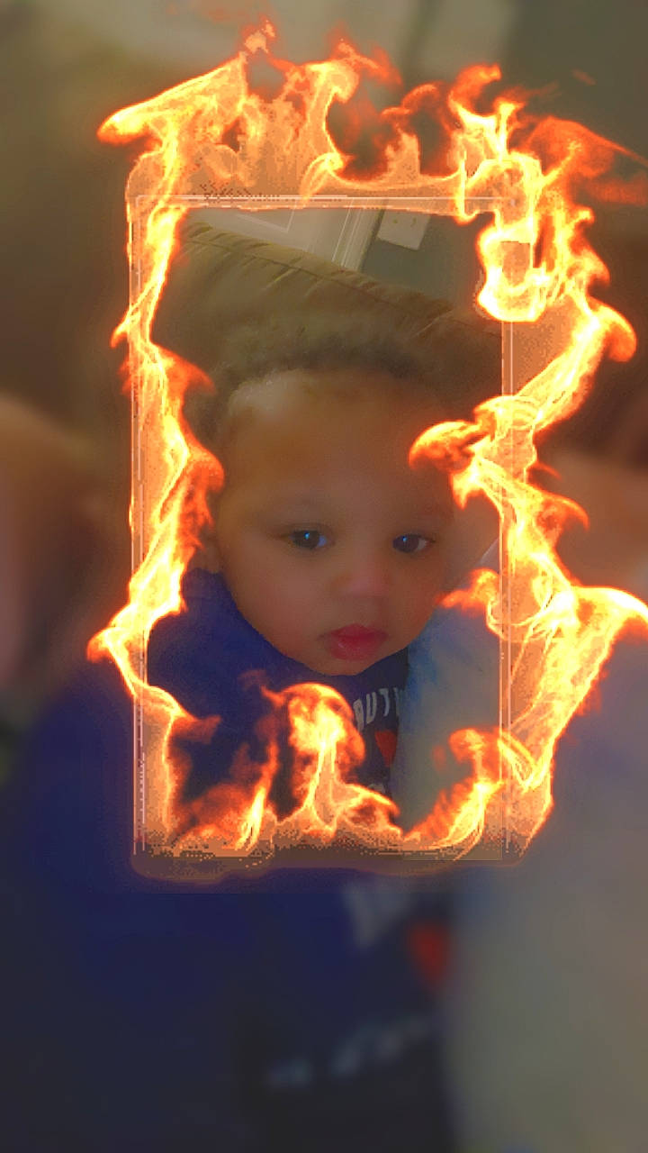 Malakai is registered to the contest to win money with this photo: art, beauty, darkness, event, fire, flame, flash_photography, fun, gas, happy, heat, holiday, interior_design, night, orange, ornament, person, portrait_photography, still_life_photography, toddler