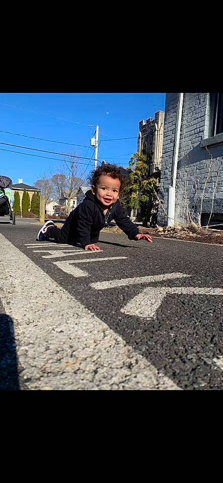 Jayson is registered to the contest to win money with this photo: asphalt, cobblestone, flooring, infrastructure, person, photography, road, road_surface, shadow, sidewalk, sitting, street