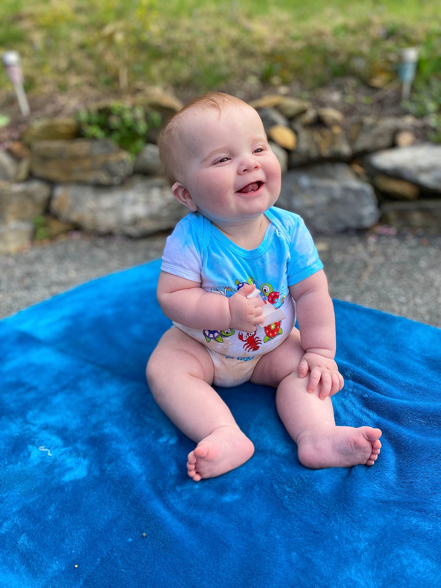Shawn is registered to the contest to win money with this photo: baby, baby_toddler_clothing, barefoot, eye, fun, grass, happy, head, leaf, leg, leisure, mouth, people_in_nature, person, plant, skin, smile, summer, t_shirt, toddler