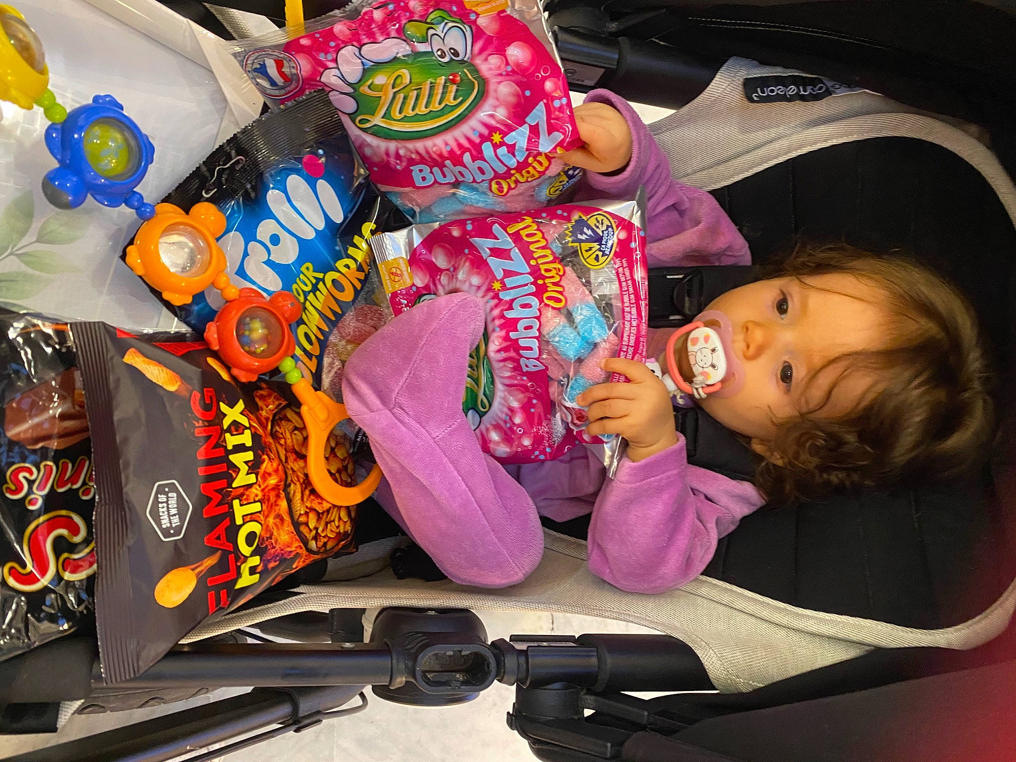 Cinthia participe au concours pour gagner de l'argent avec cette photo : baby, baby_toddler_clothing, child, food, fun, magenta, packaging_and_labeling, person, plastic, room, sleeve, snack, toddler, toy