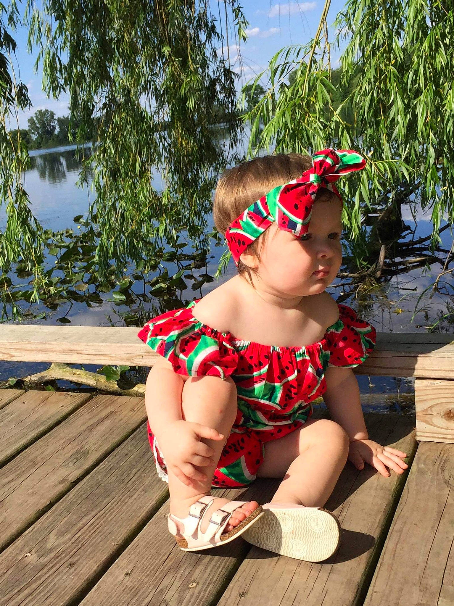 Kaydence is registered to the contest to win money with this photo: child, deck, dress, eyewear, fashion_accessory, fawn, glasses, hair_accessory, headband, headgear, leisure, pattern, person, plant, red, sitting, summer, sunglasses, textile, toddler
