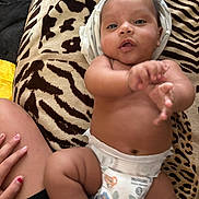 Zoriann joined the competition — help win amazing prizes! baby, diaper, hand, blanket, pattern, skin, infant, cute, lying_down, child, nail_polish, person, fingers, legs, torso, soft_texture, comfort, indoors, relaxed, closeup