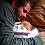 Phoebe is registered to the contest to win money with this photo: man, baby, sleeping, blanket, bed, pillow, tattoo, closeup, indoor, family, rest, cozy, affection, father, newborn, portrait, people, skin, love, quiet